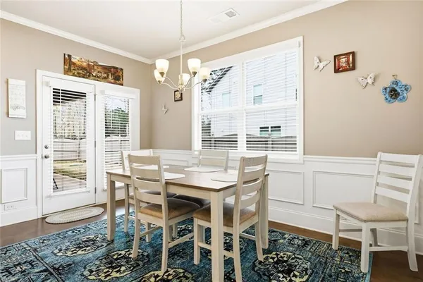a view of a dining room with furniture and a chandelier