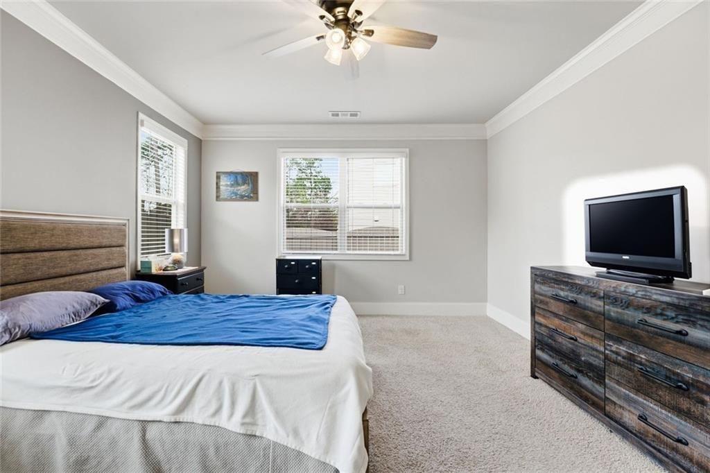 419 After Glow Summit Canton, GA 30114 - Photo 29 of 41 a bedroom with a bed and a flat screen tv