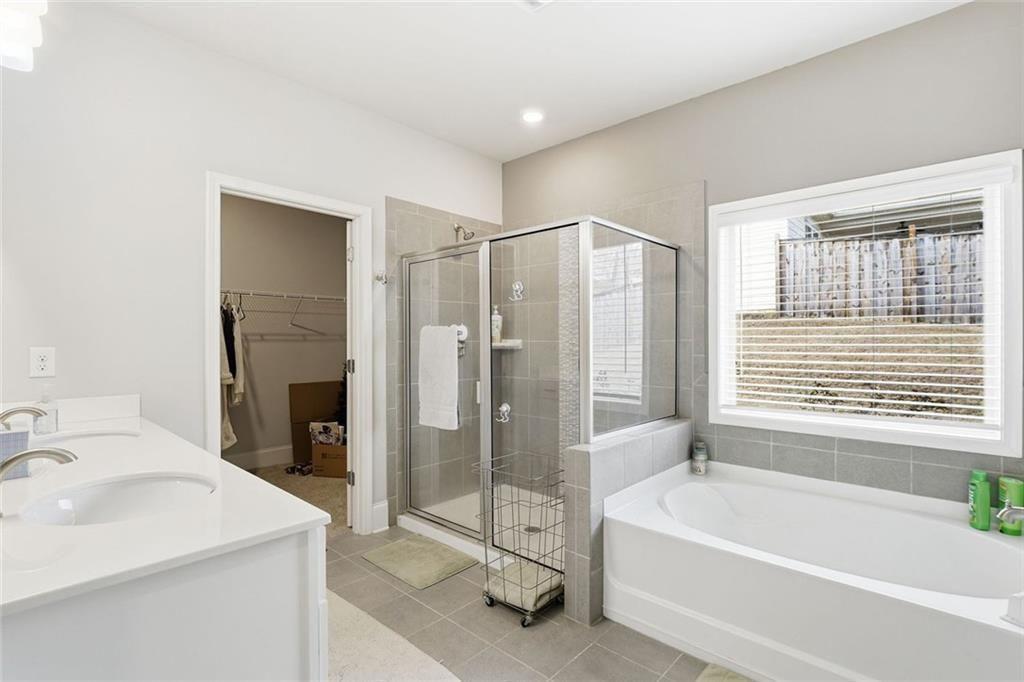 419 After Glow Summit Canton, GA 30114 - Photo 30 of 41 a spacious bathroom with a tub sink shower and mirror