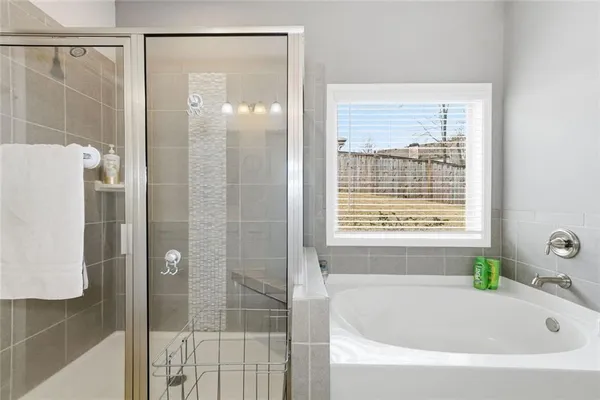 a bathroom with a bathtub and shower