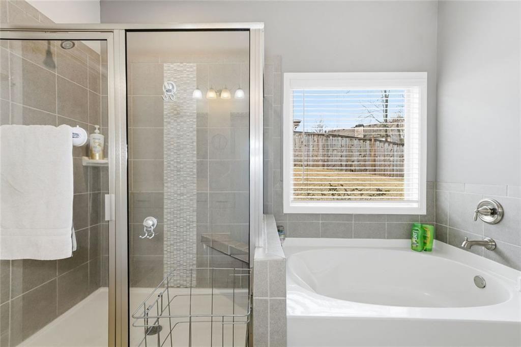 419 After Glow Summit Canton, GA 30114 - Photo 32 of 41 a bathroom with a bathtub and shower
