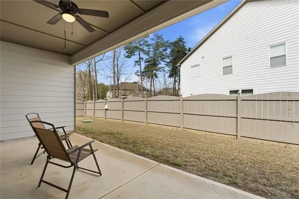 a view of backyard and wooden fence