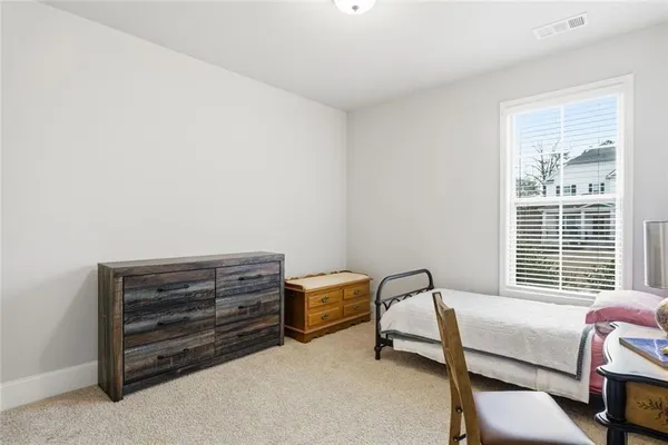 a bedroom with furniture and a window