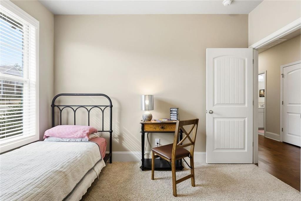 419 After Glow Summit Canton, GA 30114 - Photo 9 of 41 a bedroom with a bed a table and chair