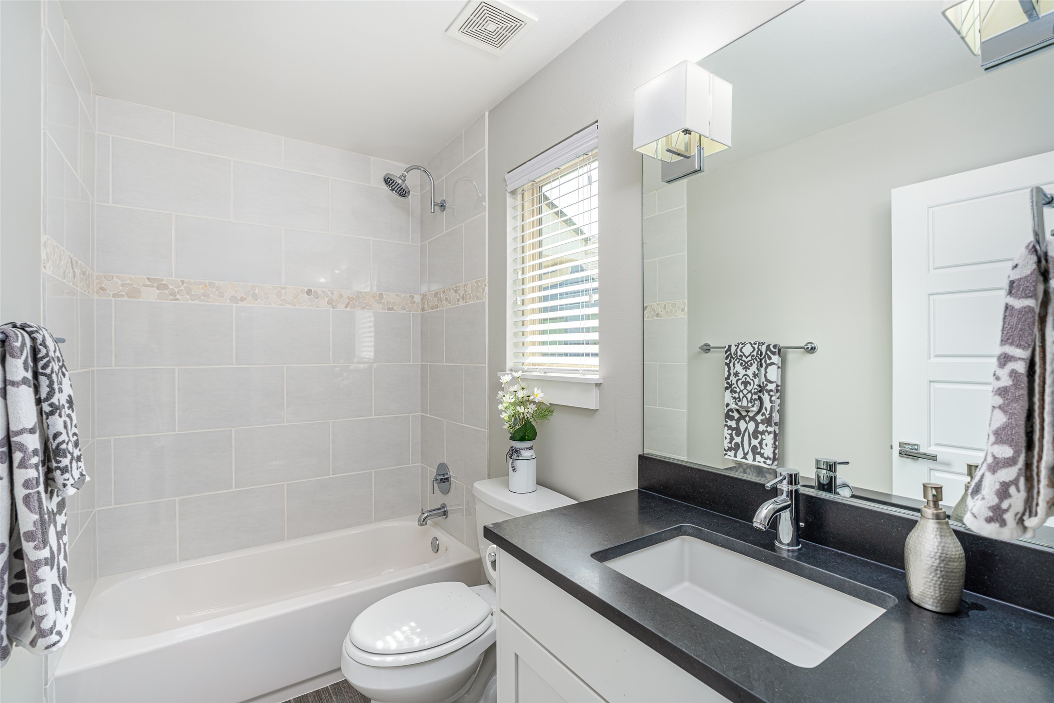 705 East 49th Street, Unit A Austin, TX 78751 - Photo 24 of 40 a bath room with a toilet a sink and a bath tub