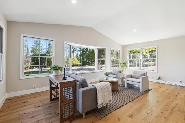 a view of a dining room with furniture and chandelier