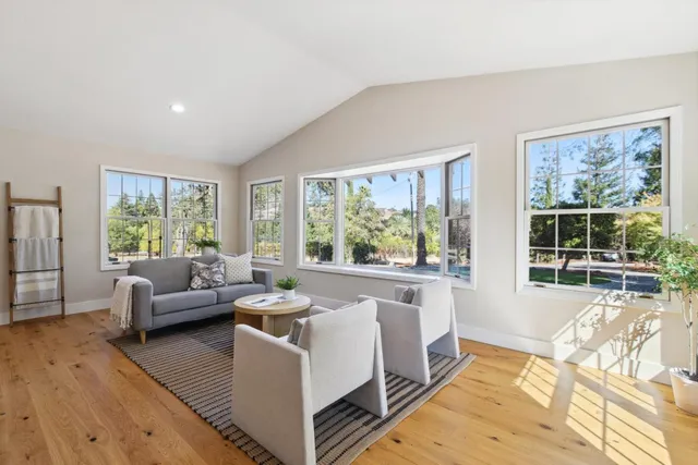 a living room with furniture a dining table and kitchen view