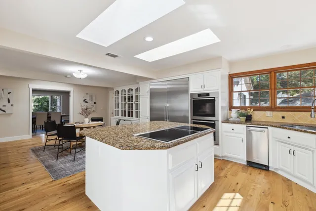 a bathroom with double vanity sink a mirror and a bathtub