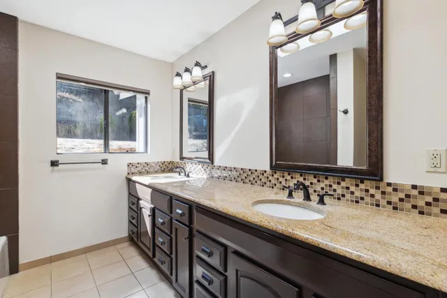 a kitchen with stainless steel appliances granite countertop a sink a stove and refrigerator