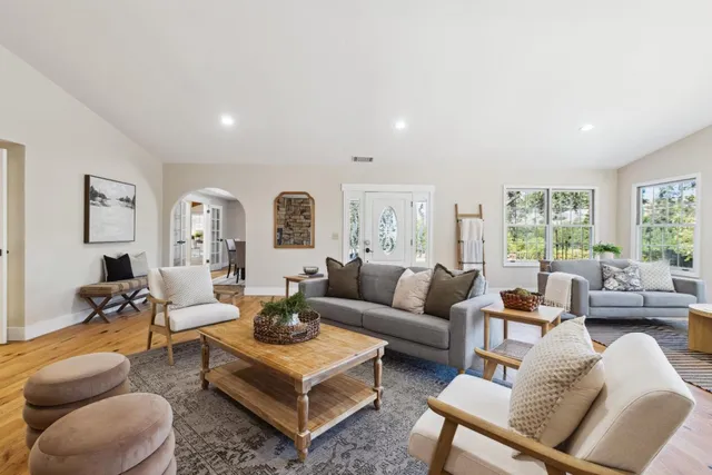 a bedroom with furniture and a large window