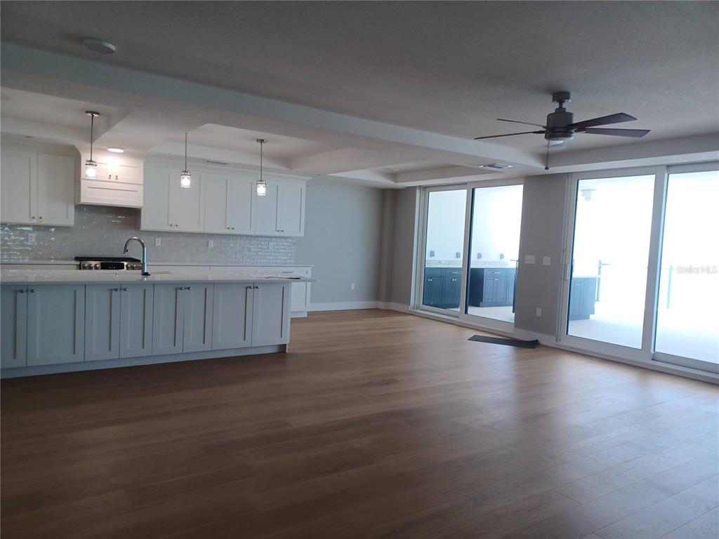 14048 Gulf Boulevard, Unit 401 Madeira Beach, FL 33708 - Photo 3 of 14 a view of an empty room with a window and wooden floor