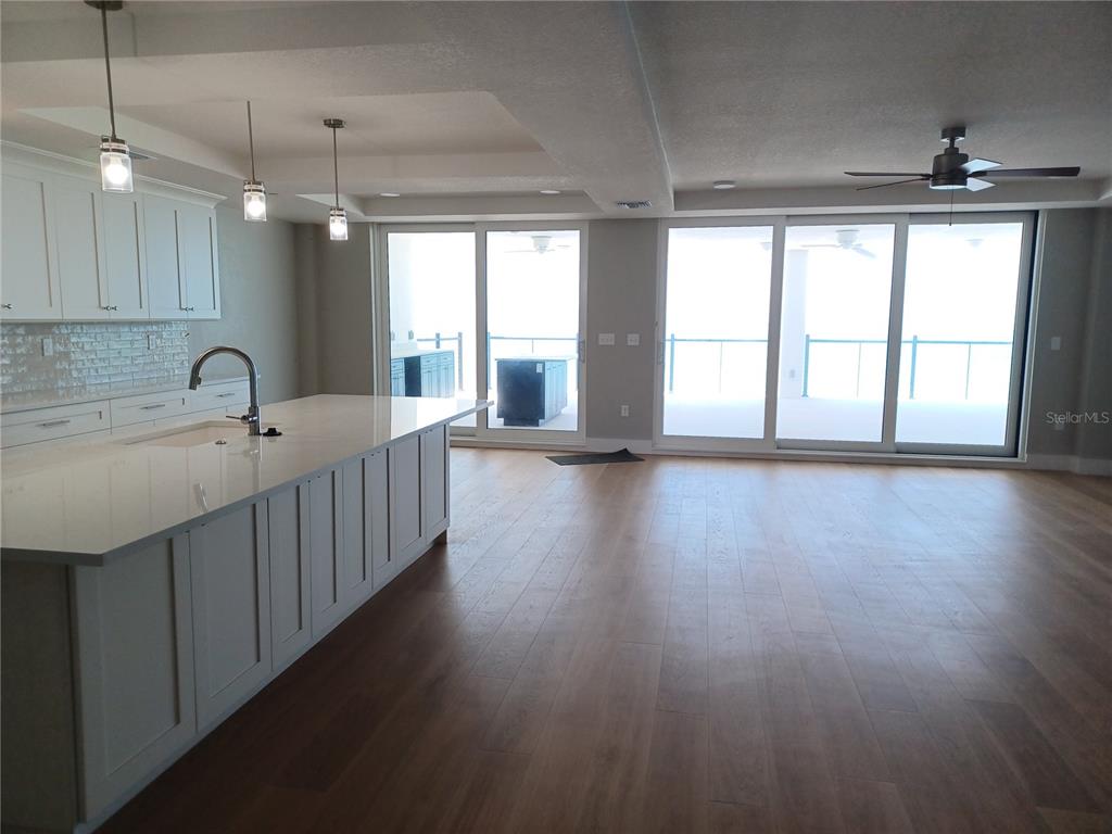 14048 Gulf Boulevard, Unit 401 Madeira Beach, FL 33708 - Photo 6 of 14 a kitchen with stainless steel appliances a sink window and wooden floor
