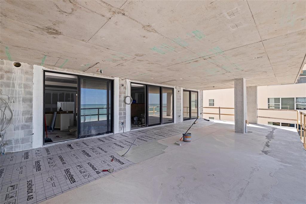 14048 Gulf Boulevard, Unit 401 Madeira Beach, FL 33708 - Photo 6 of 14 a spacious bedroom with a large bed and a large window