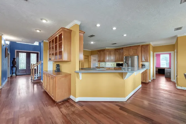 a view of hall way with wooden floor and windows