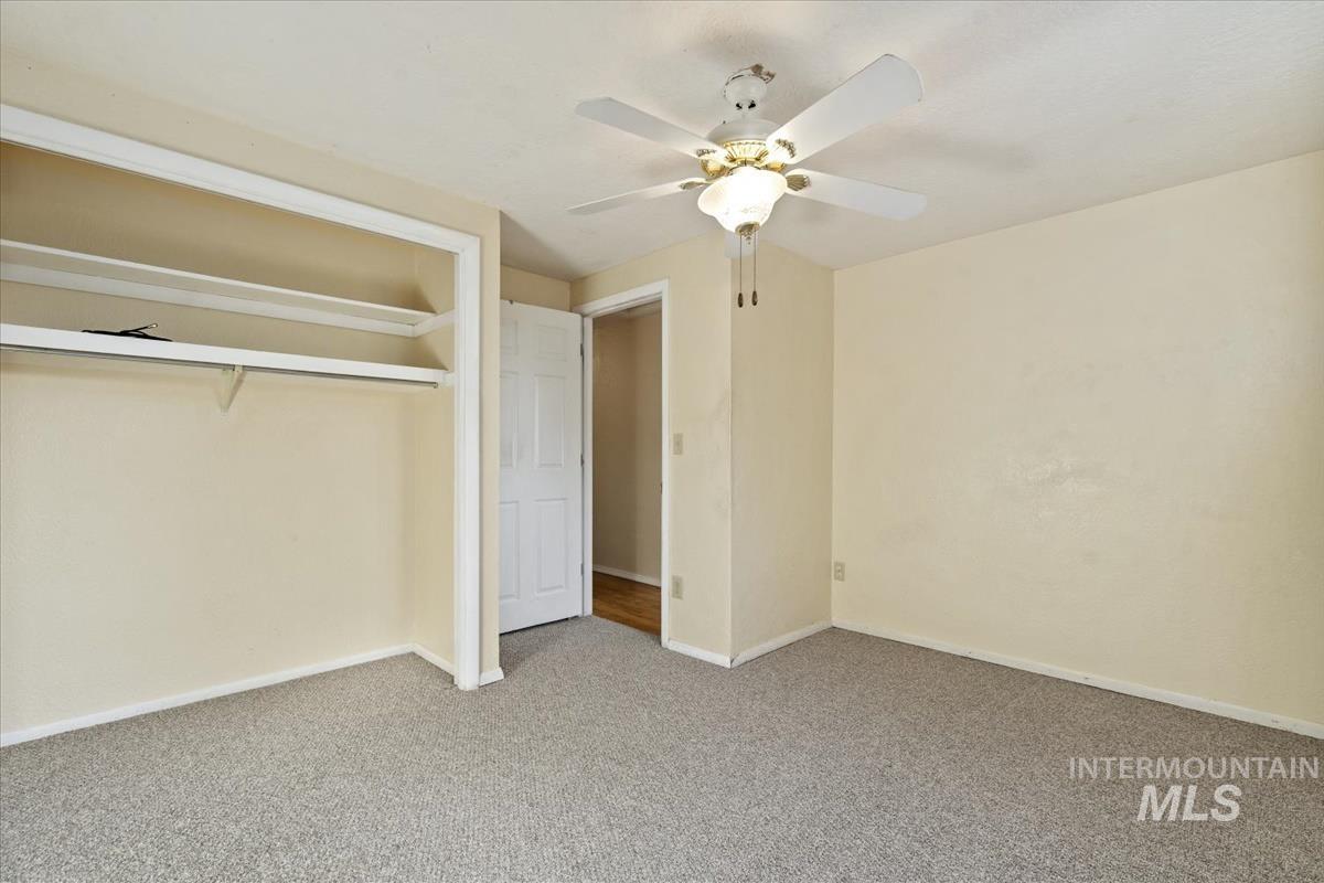 351 East 3rd Street Kuna, ID 83634 - Photo 20 of 42 Unfurnished bedroom featuring carpet, a closet, and a ceiling fan