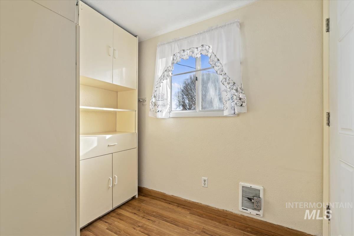 351 East 3rd Street Kuna, ID 83634 - Photo 26 of 42 Unfurnished bedroom featuring light wood-style floors and heating unit