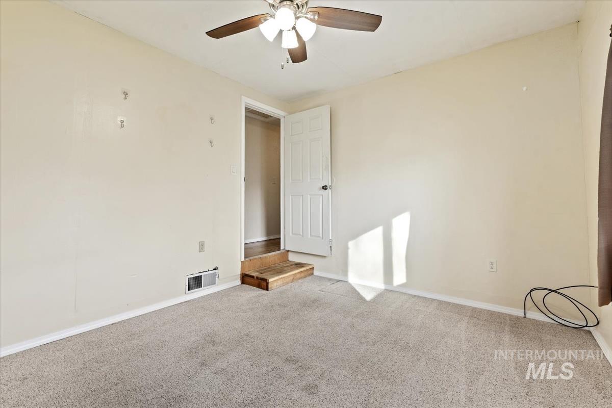 351 East 3rd Street Kuna, ID 83634 - Photo 30 of 42 Empty room featuring carpet floors and a ceiling fan