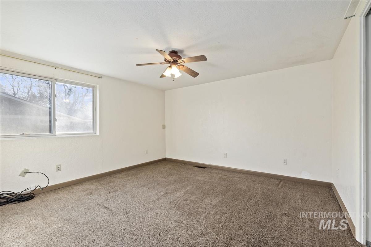 351 East 3rd Street Kuna, ID 83634 - Photo 31 of 42 Carpeted spare room with ceiling fan and baseboards