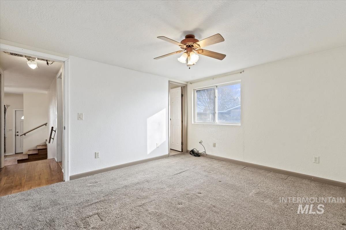 351 East 3rd Street Kuna, ID 83634 - Photo 32 of 42 Spare room with carpet, a ceiling fan, and a textured ceiling