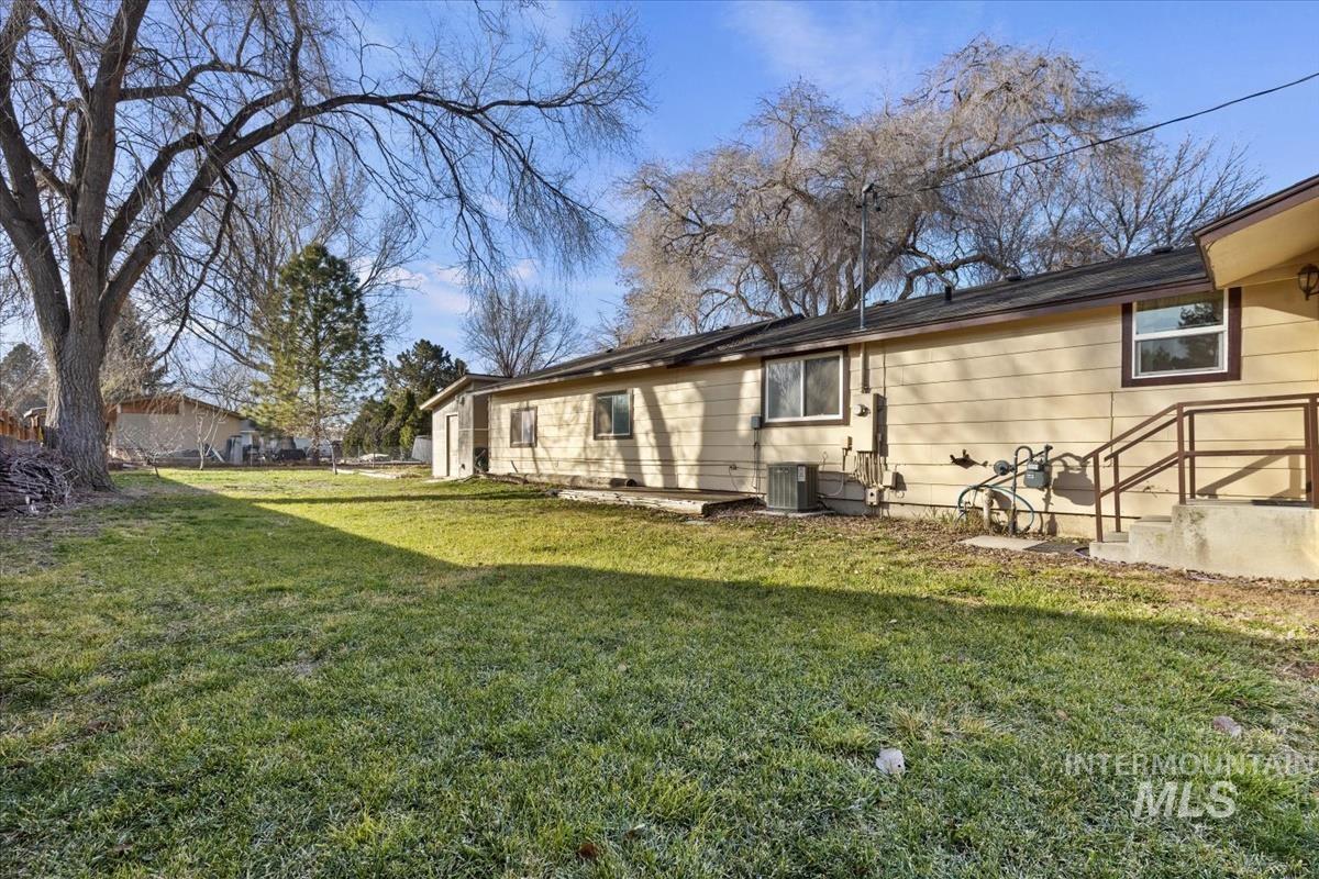 351 East 3rd Street Kuna, ID 83634 - Photo 33 of 42 Rear view of house with a lawn