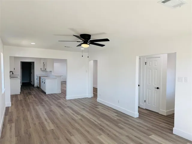 a view of a kitchen with a sink and a refrigerator