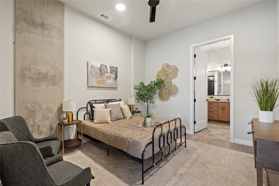 4510 Terry-O Lane, Unit 128 Austin, TX 78745 - Photo 14 of 29 a bedroom with a bed a couch and a potted plant