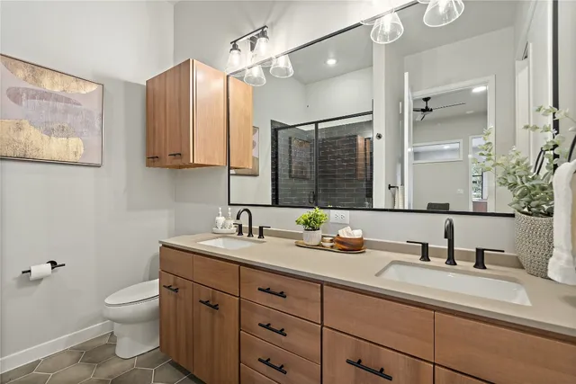 a bathroom with a granite countertop toilet sink and a mirror