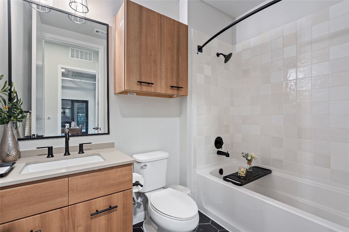 4510 Terry-O Lane, Unit 128 Austin, TX 78745 - Photo 4 of 29 a bathroom with a sink a toilet and shower