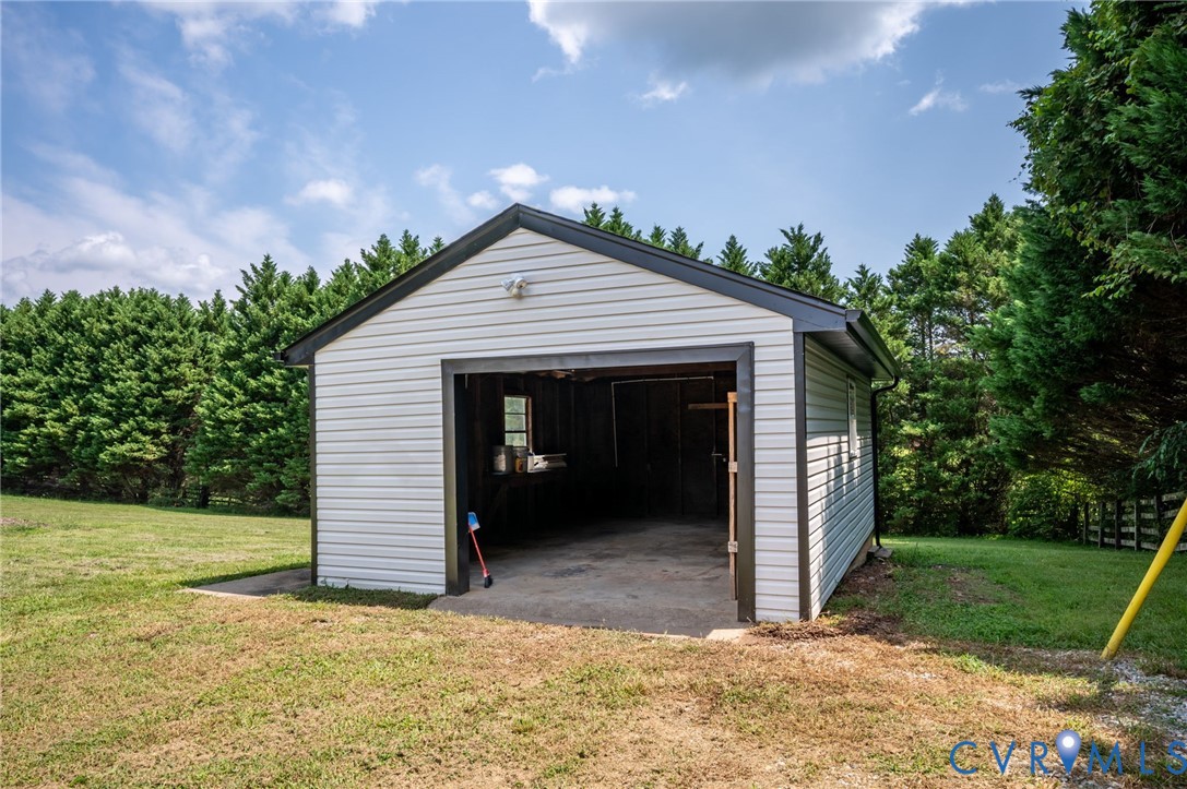 Detached outbuilding with an open bay and durable