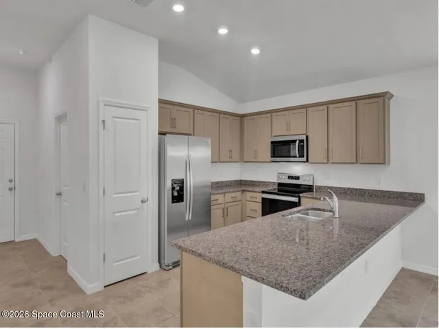a kitchen with cabinets and stainless steel appliances