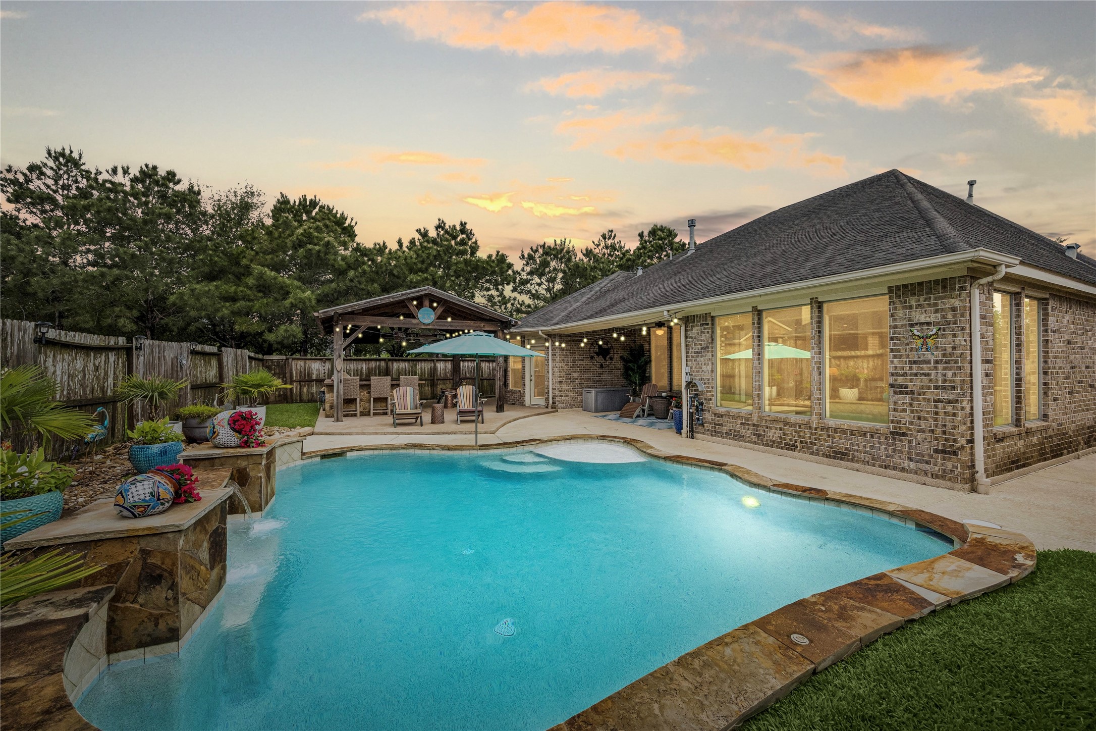 BACKYARD RETREAT: Resort-style pool, shaded outdoor living, and multiple spaces to relax or entertain create a private escape designed for everyday living.