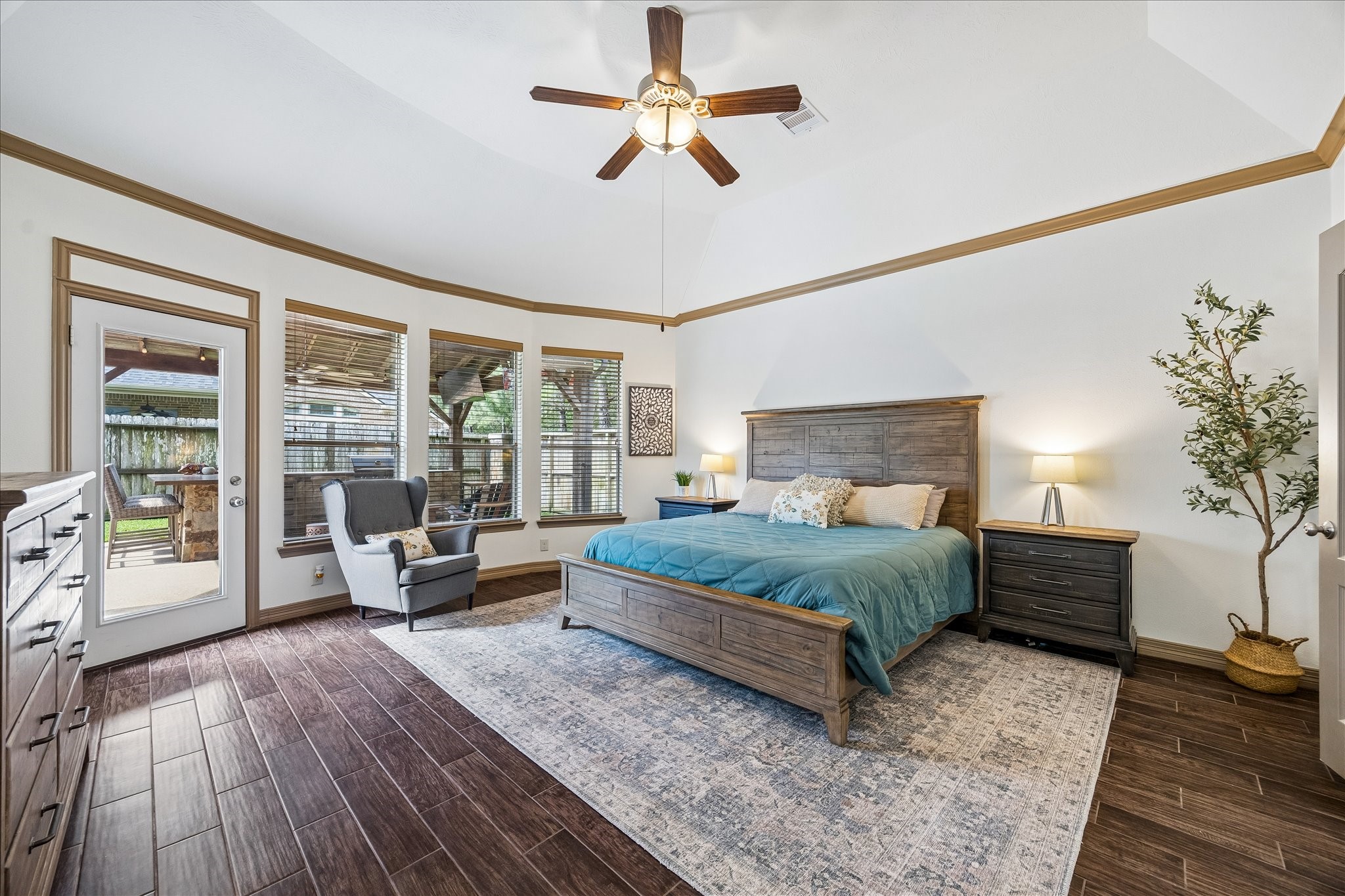 28211 Rippling Brook Lane Fulshear, TX 77441 - Photo 18 of 45 PRIVATE RETREAT: Spacious primary suite featuring elevated ceilings, crown molding, and a bay window sitting area, all complemented by direct access to the backyard and pool.