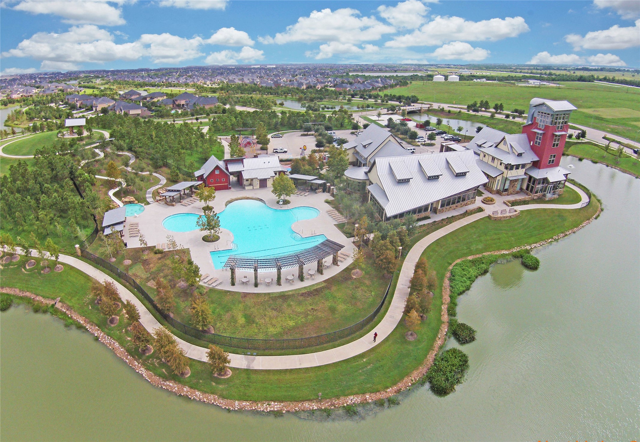 28211 Rippling Brook Lane Fulshear, TX 77441 - Photo 38 of 45 RESORT LIVING: Adventure Island Waterpark offers a true getaway with a massive pool, 140’ water slide, and scenic lake views, creating a one-of-a-kind community experience.