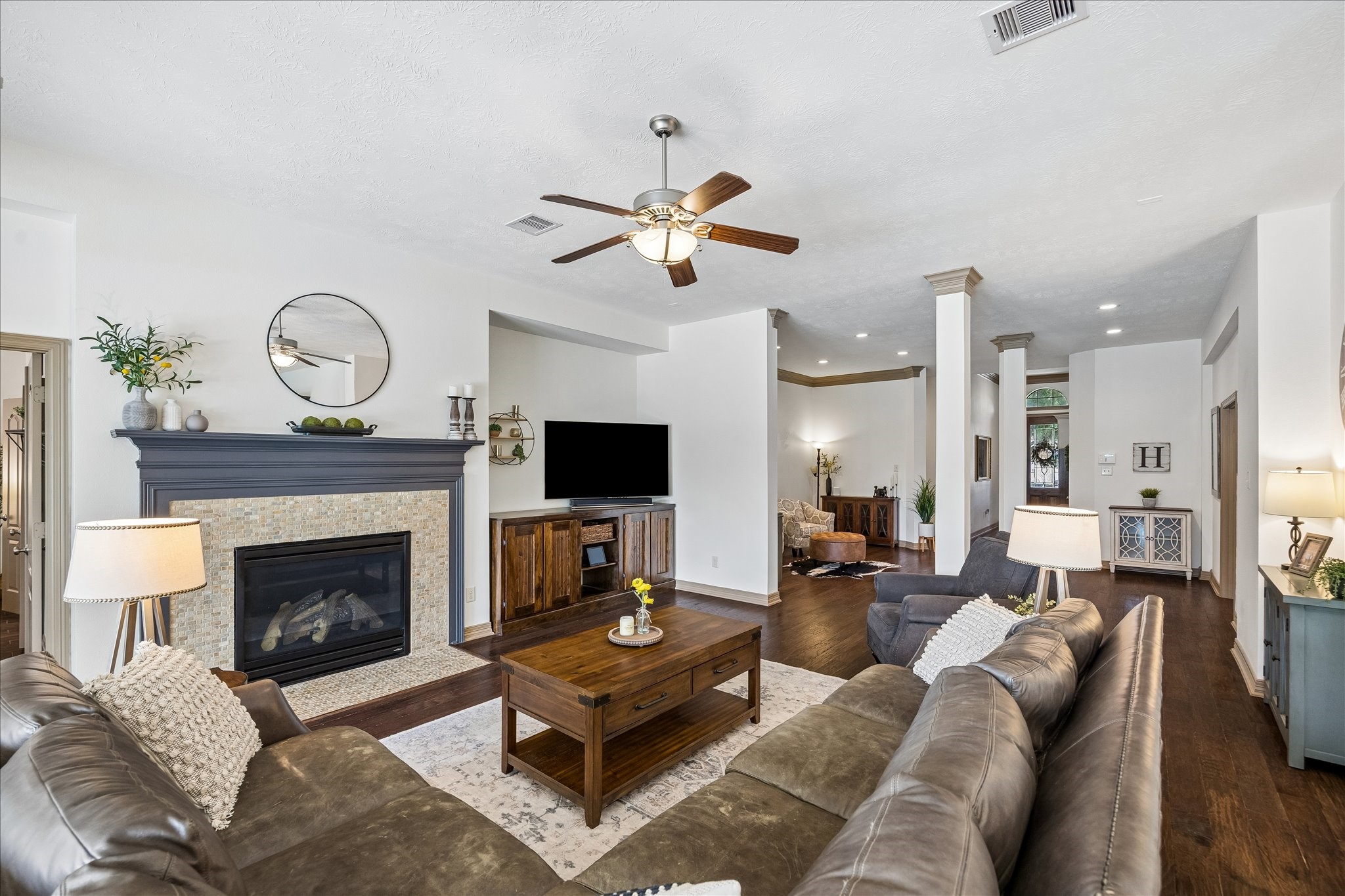 28211 Rippling Brook Lane Fulshear, TX 77441 - Photo 8 of 45 SEAMLESS FLOW: Thoughtfully designed sightlines connect the living room to the kitchen, creating an open yet functional space for gathering and hosting.