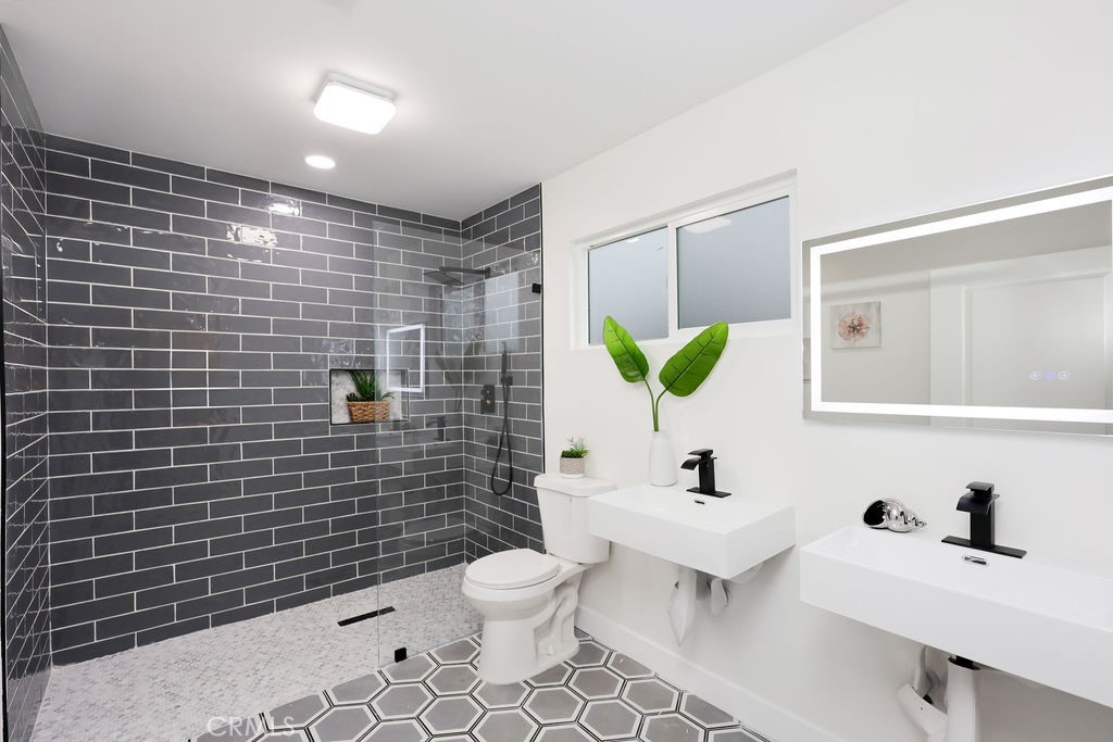 916 North West Street Anaheim, CA 92801 - Photo 17 of 27 a bathroom with a sink mirror and toilet