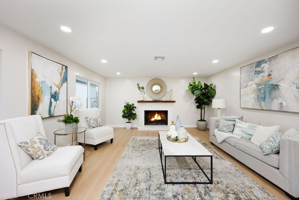 916 North West Street Anaheim, CA 92801 - Photo 7 of 27 a living room with furniture a fireplace and a painting on the wall