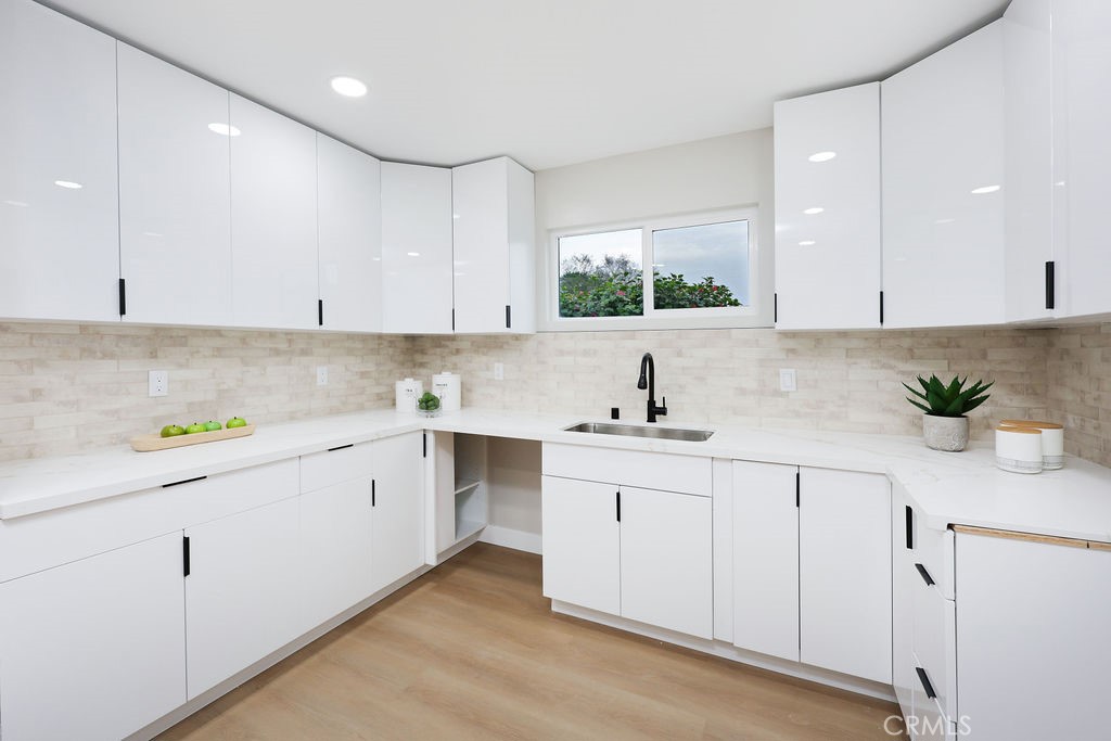 916 North West Street Anaheim, CA 92801 - Photo 9 of 27 a kitchen with white cabinets white appliances and a sink