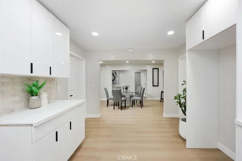 a living room with furniture and potted plant