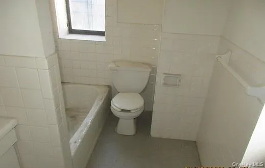 a utility room with a sink a vanity and a window