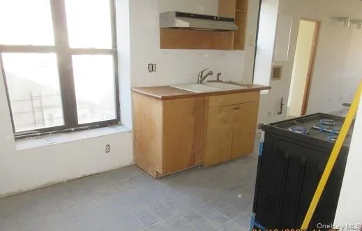 a kitchen that has a sink and a stove in it