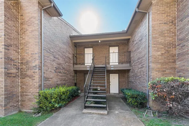 a front view of a house with stairs