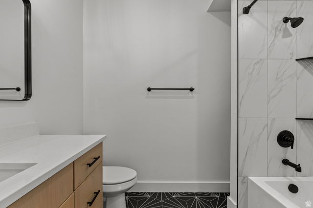 3111 South 1250 West Logan, UT 84321 - Photo 35 of 51 Bathroom featuring a light wood-finish vanity with a white countertop and undermount sink, a sleek black-framed mirror, and matte black hardware