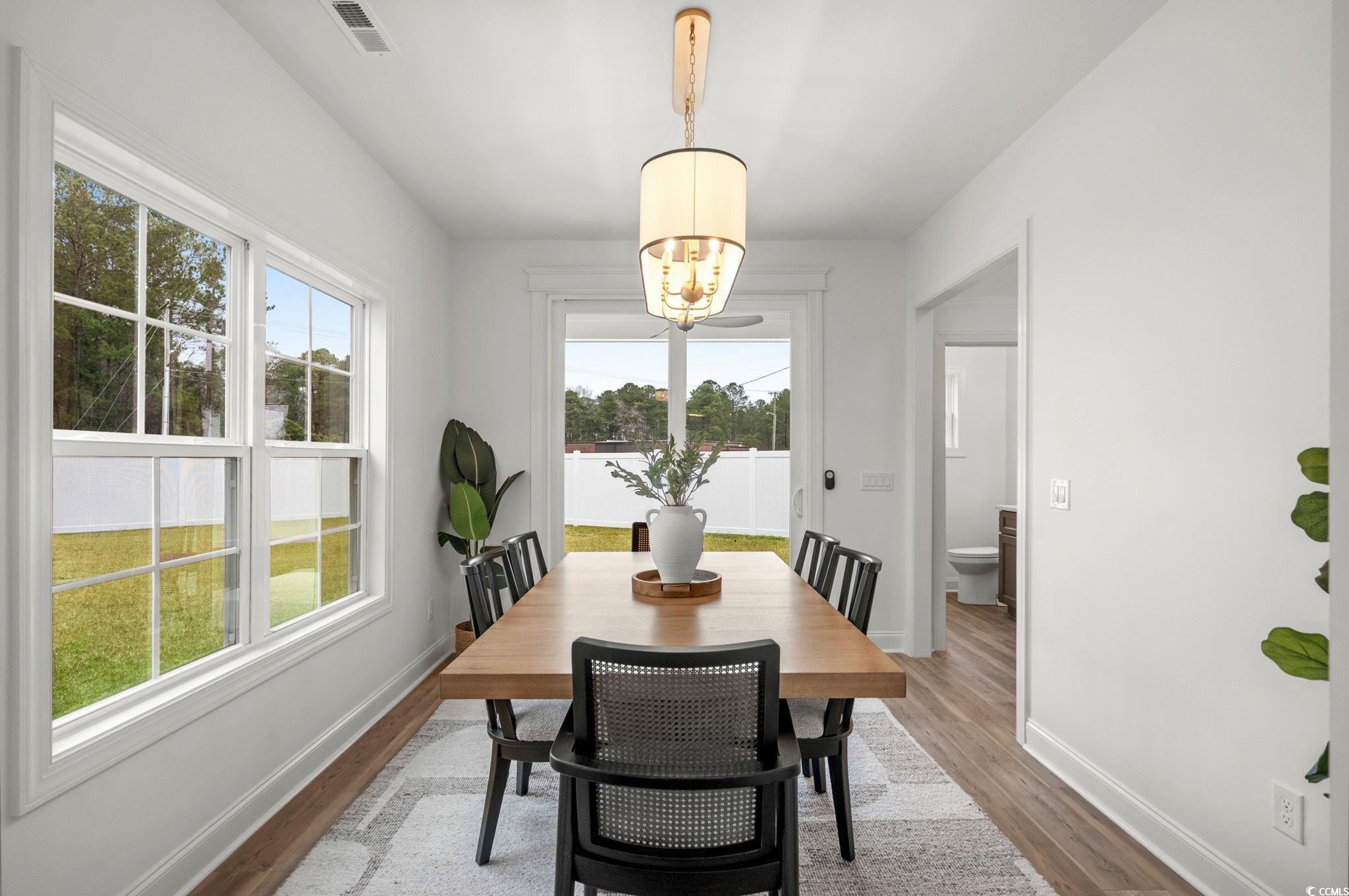 156 Arbor Ridge Circle Conway, SC 29526 - Photo 14 of 40 Dining space featuring wood finished floors and a chandelier