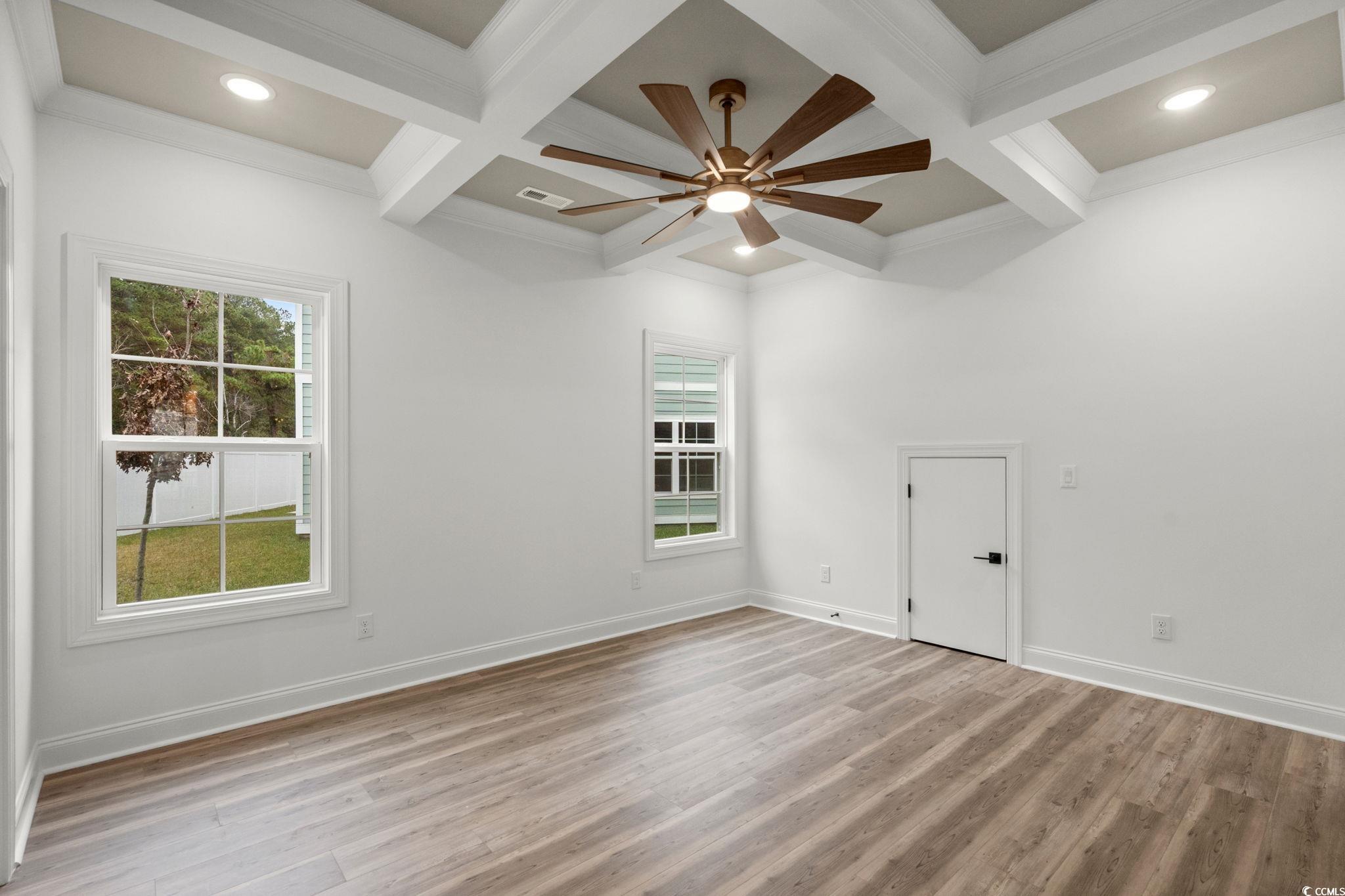 156 Arbor Ridge Circle Conway, SC 29526 - Photo 21 of 40 Unfurnished room with coffered ceiling, beamed ceiling, plenty of natural light, light wood-type flooring, and ceiling fan