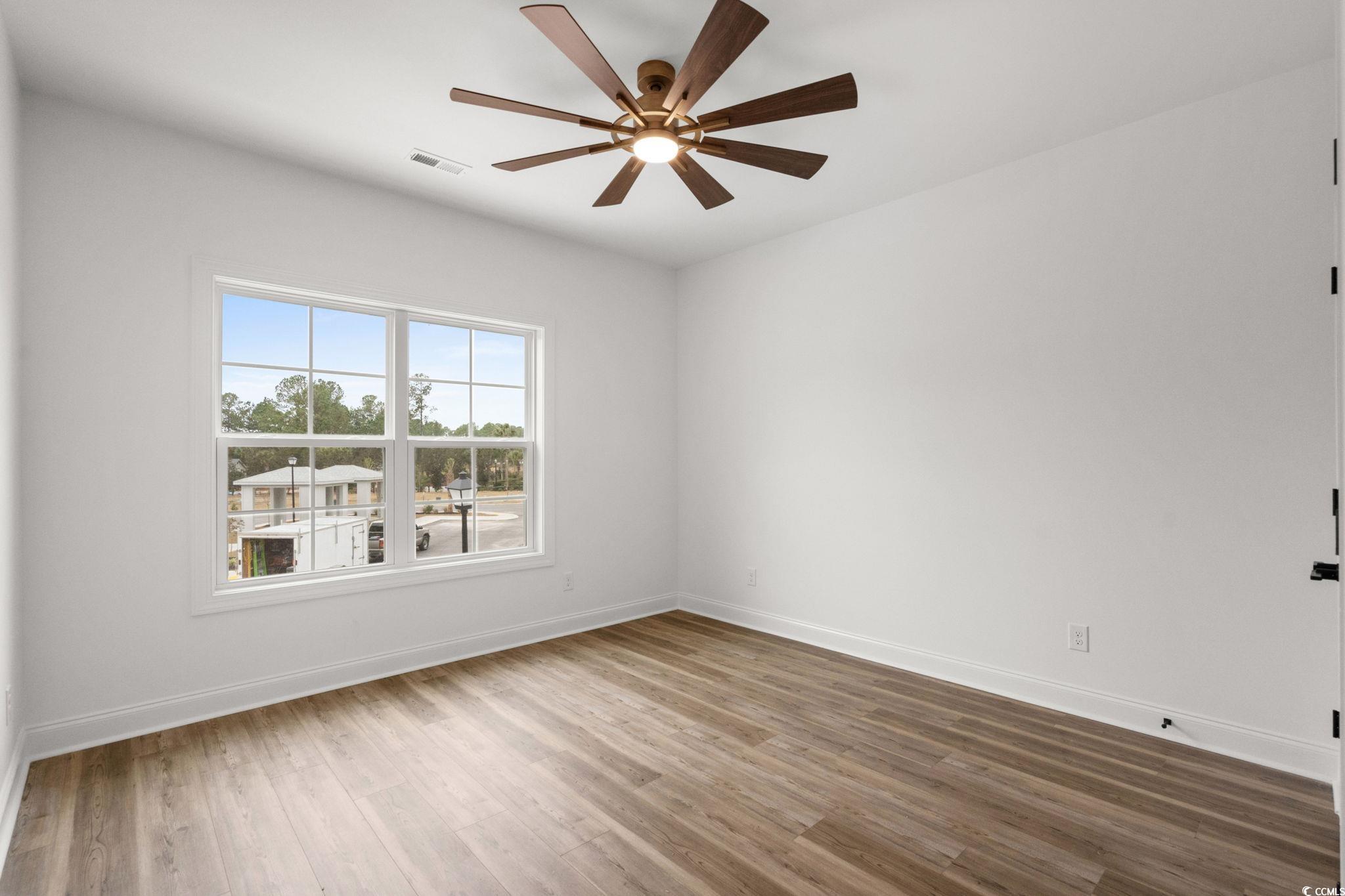 156 Arbor Ridge Circle Conway, SC 29526 - Photo 30 of 40 Empty room with light wood-style floors and ceiling fan
