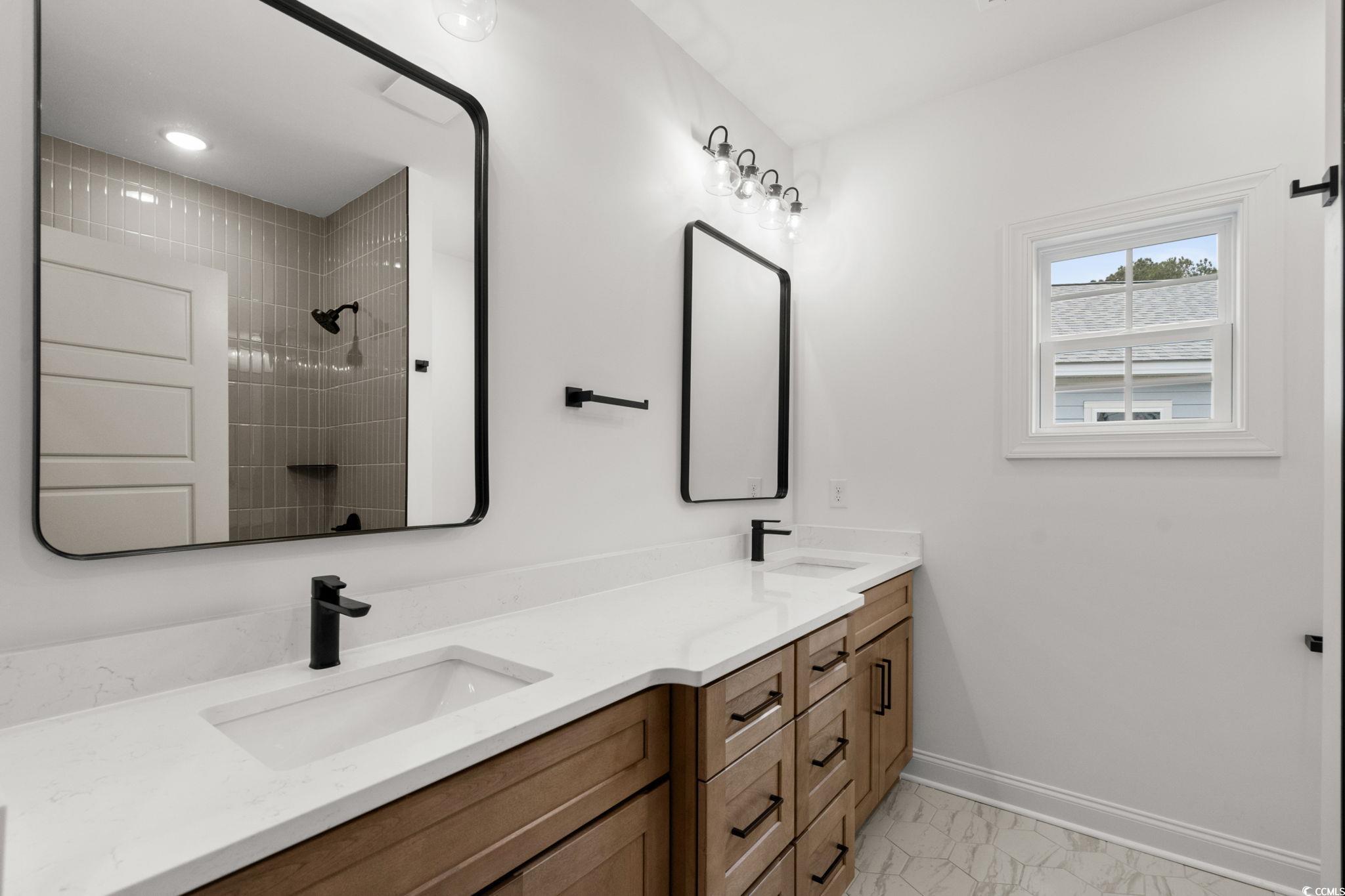 156 Arbor Ridge Circle Conway, SC 29526 - Photo 32 of 40 Bathroom with double vanity, light marble finish floors, and a tile shower