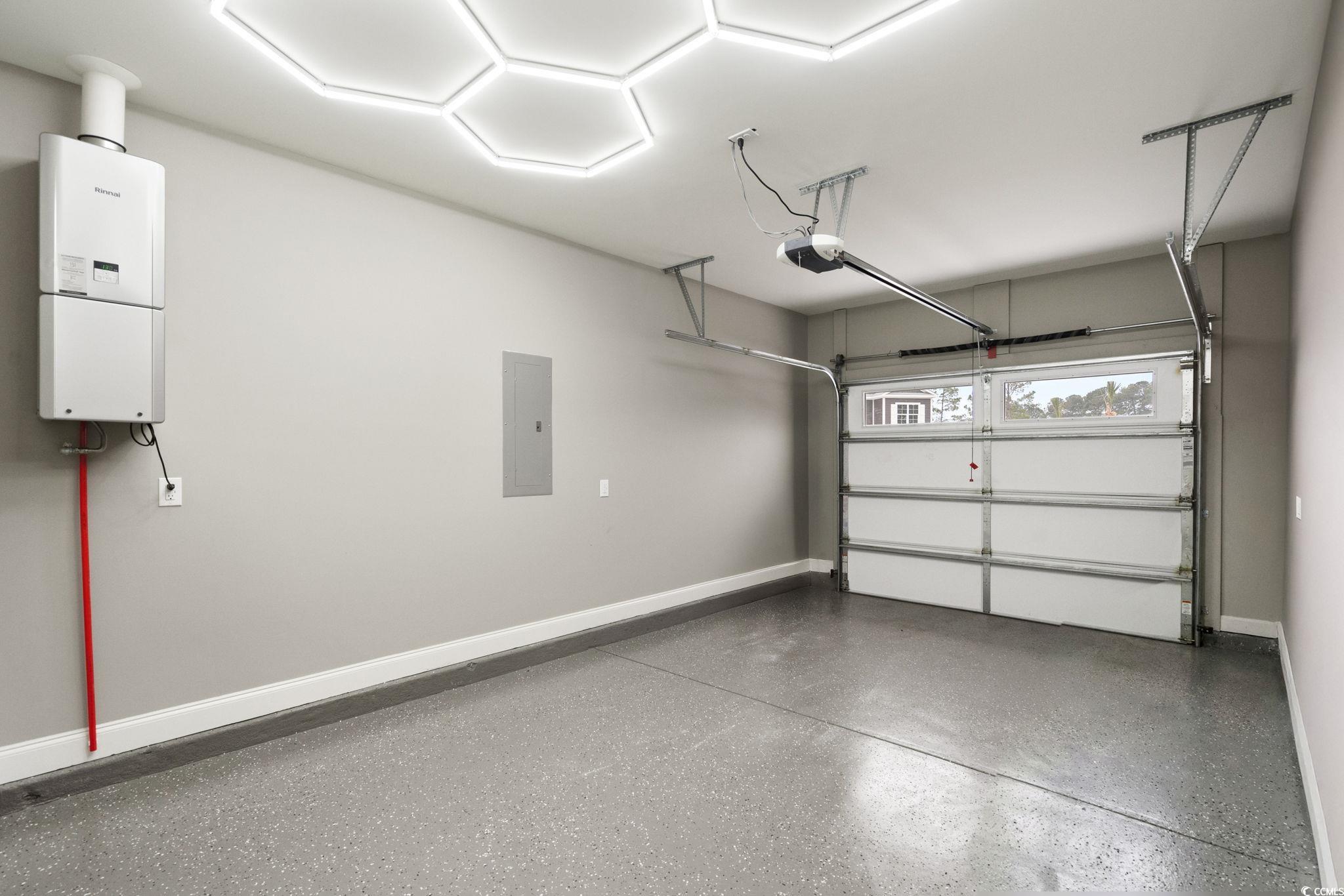 156 Arbor Ridge Circle Conway, SC 29526 - Photo 39 of 40 Garage featuring electric panel, tankless water heater, and a garage door opener