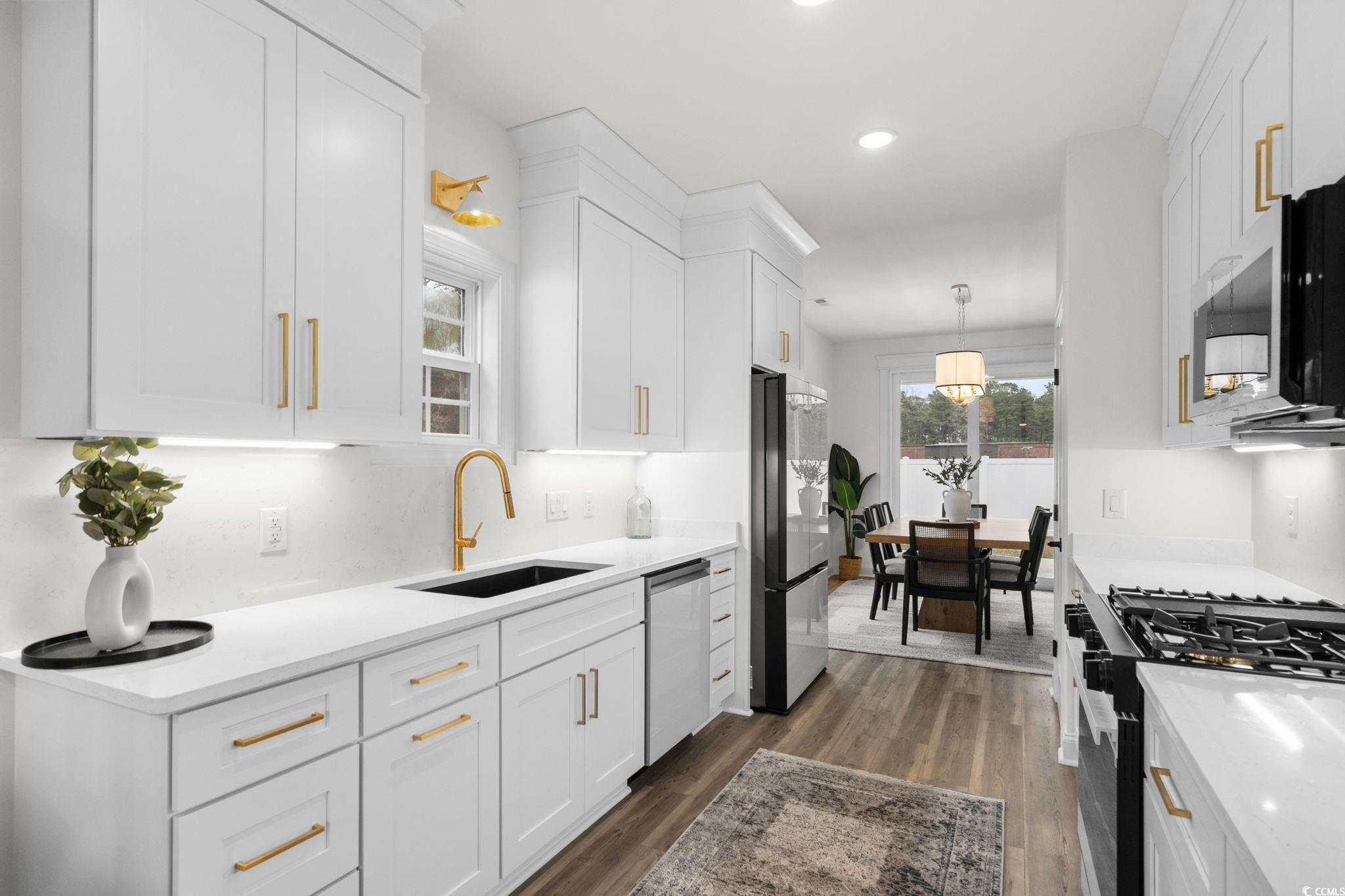 156 Arbor Ridge Circle Conway, SC 29526 - Photo 10 of 40 Kitchen with decorative light fixtures, dark wood-type flooring, light stone counters, white cabinets, and recessed lighting
