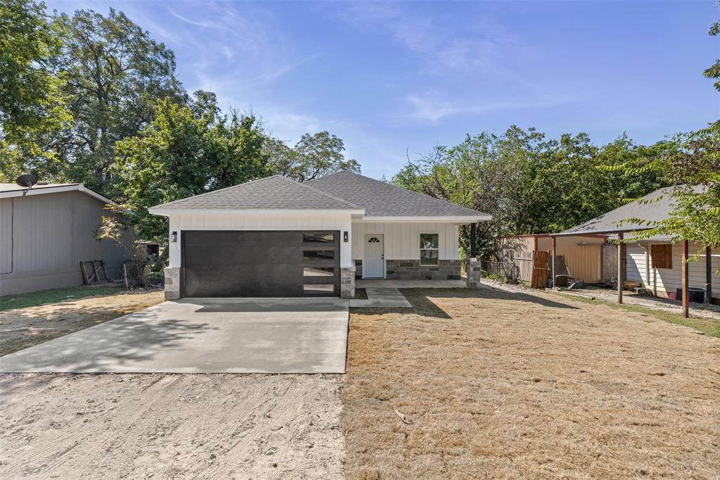 506 2nd Street Moody, TX 76557 - Photo 3 of 40 a front view of a house with a yard and a garage