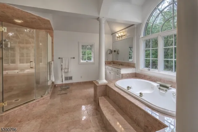 a bathroom with a tub a sink and a shower